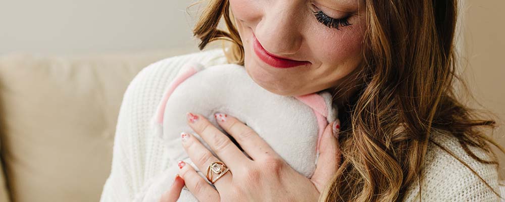 Mother holding baby wearing JEREMYTIS
